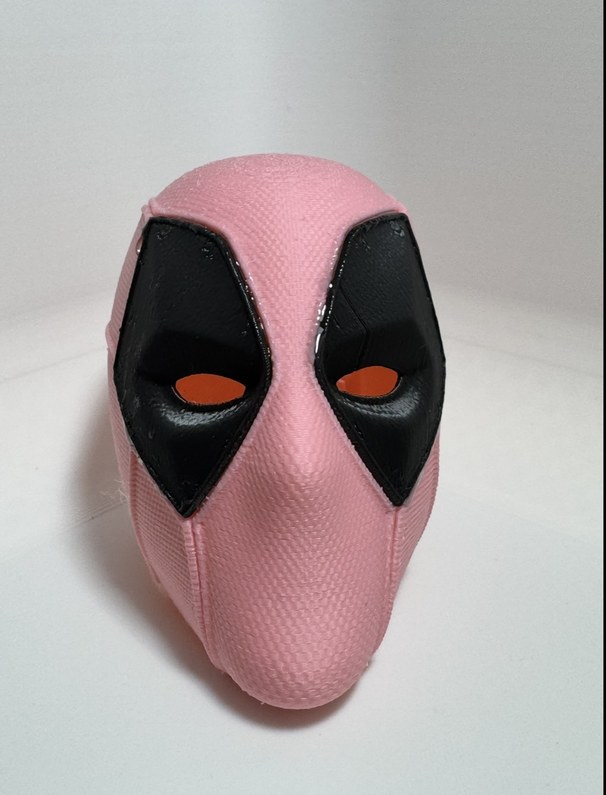 Small pink 3D printed helmet, front view