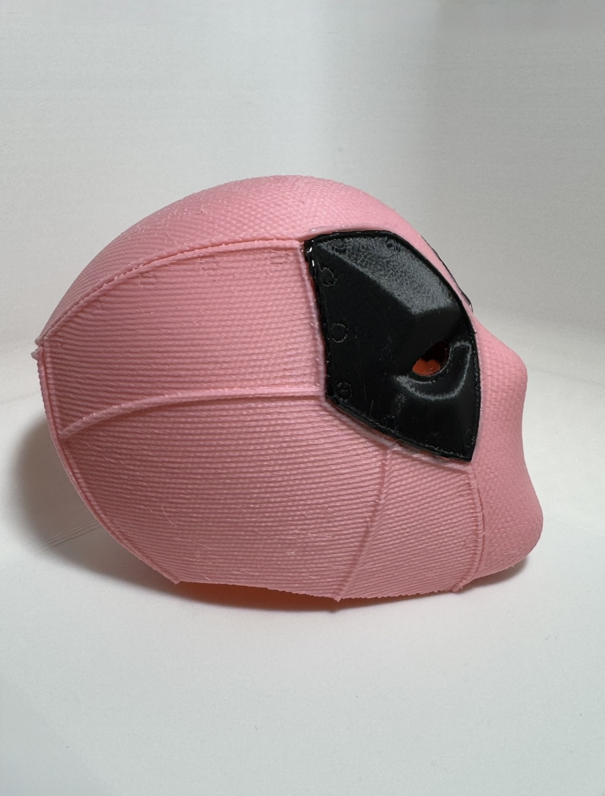 Small pink 3D printed helmet, side view