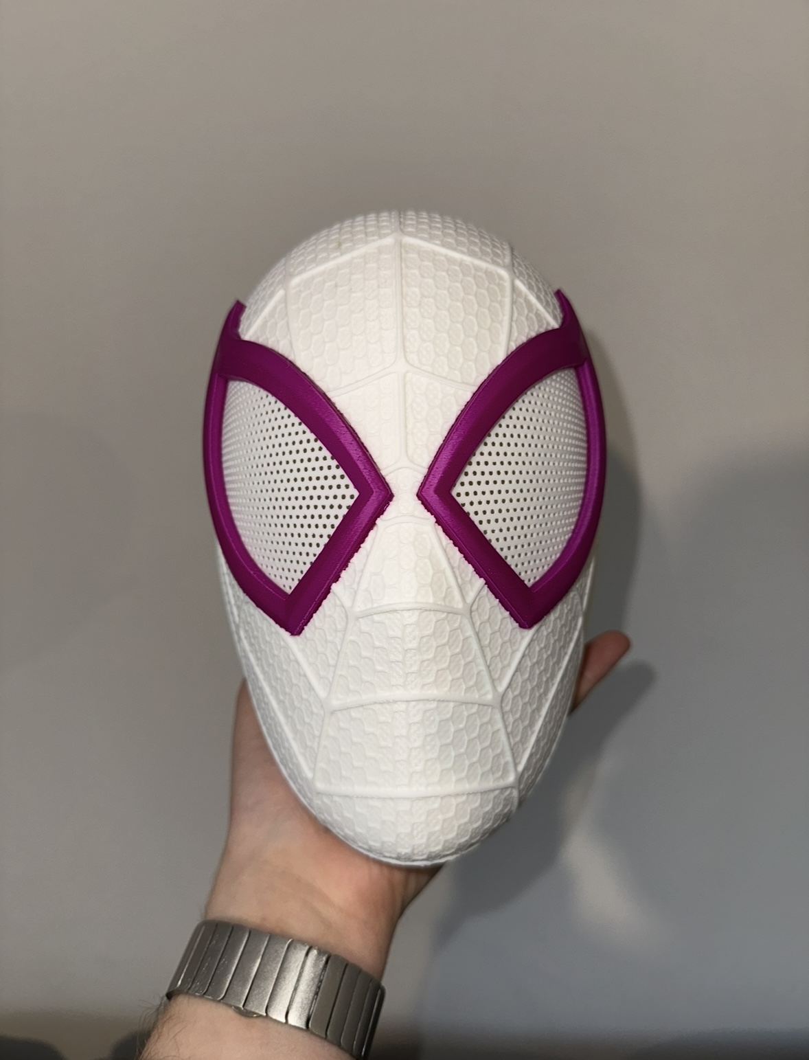 Small 3D printed helmet with a web design, white version, front view